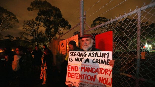 People gather at a vigil outside the Broadmeadows Detention Centre to try to halt the transfer of 20 asylum seekers to a detention camp on Nauru.