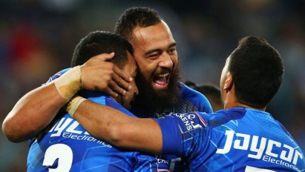 Dogs bare their teeth: Canterbury players Sam Kasiano, Krisnan Inu and Drury Low celebrate during the upset win over Manly.