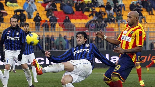 Inter Milan's Diego Milito fights for the ball with Lecce's Ruben Olivera.