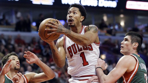 Back to his best: Chicago Bulls guard Derrick Rose drives to the basket against Milwaukee Bucks forward Ersan Ilyasova and guard Michael Carter-Williams.