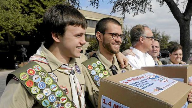 James Oliver, left, hugs his brother and fellow Eagle Scout, Will Oliver, who is gay.