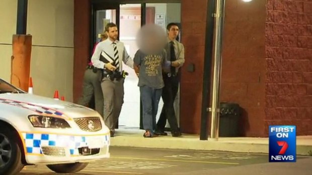 The man accused of trying to snatch a toddler from a Brisbane shopping centre leaves Stafford police station in handcuffs.