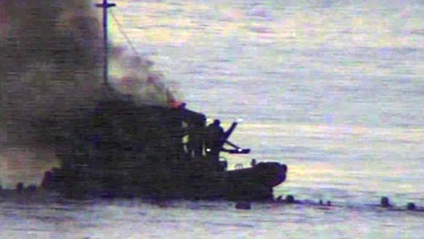 Television pictures show people in the water after the SIEV 36 exploded in flames.