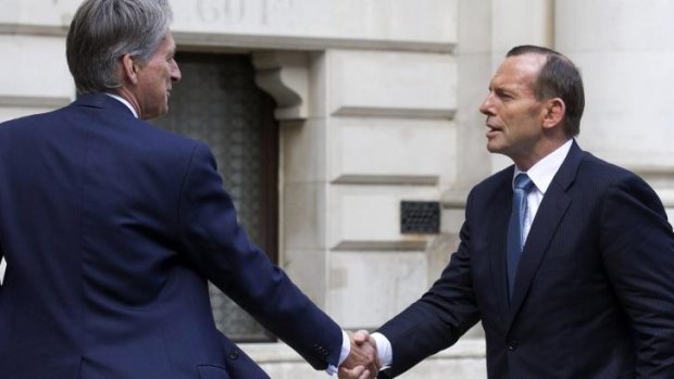 British Foreign Minister Philip Hammond greets Australian Prime Minister Tony Abbott outside the Foreign and Commonwealth Office in London.