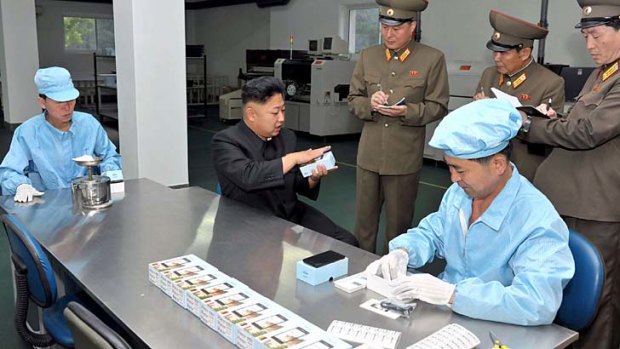 North Korean leader Kim Jong-Un inspects the Arirang smartphone.