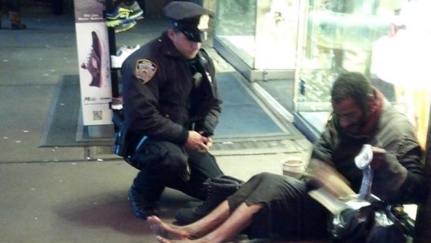 Random act of kindness ... New York police officer Larry DePrimo gives a barefoot and homeless Jeffrey Hillman some boots.