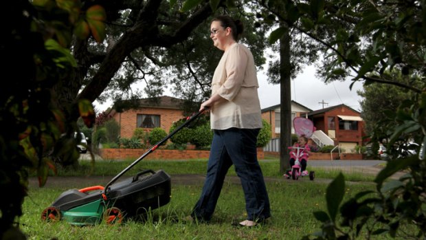 DIY works: Sydney mother Karyn Watson has taken to lawn mowing herself to save $40 she used to pay a gardener.