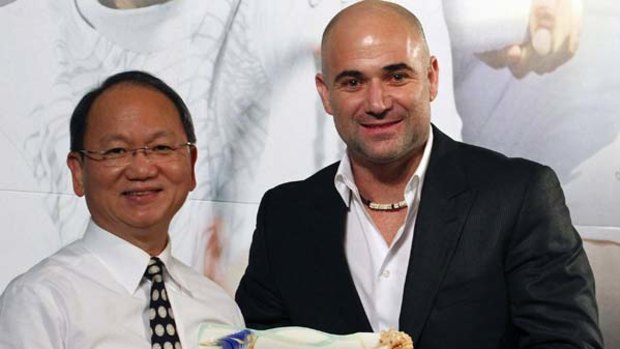 Franz Chen with American tennis great Andre Agassi after winning an auction