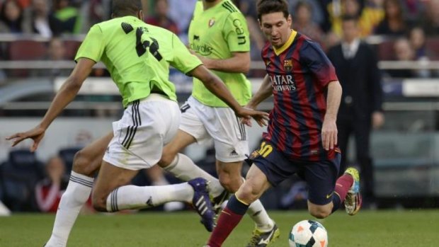 Lionel Messi of Barcelona toys with the Osasuna defence.
