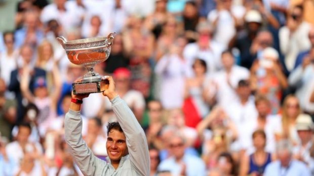 Rafael Nadal lifts the Coupe de Mousquetaires after winning his 9th French Open title.