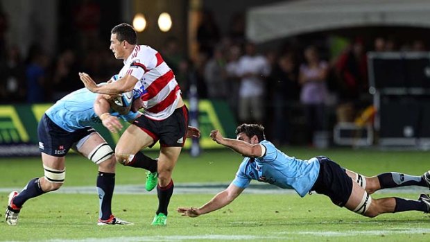 Sonny shining . . . Sonny Bill Williams of the Crusaders beats the tackles of Waratahs players Dave Dennis, right, and Ben Mowen during round three of the Super Rugby season. The Crusaders won 33-18.