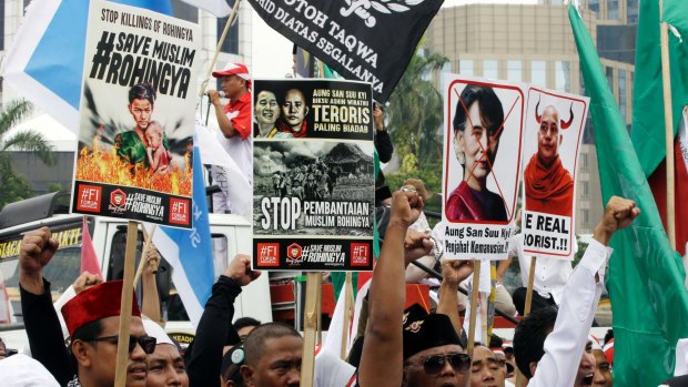 Protesters in Jakarta shout slogans as they hold posters of Aung San Suu Kyi and Wirathu, the leader of Myanmar's nationalist Buddhist monks, during a rally against the persecution of Rohingya Muslims on Saturday.