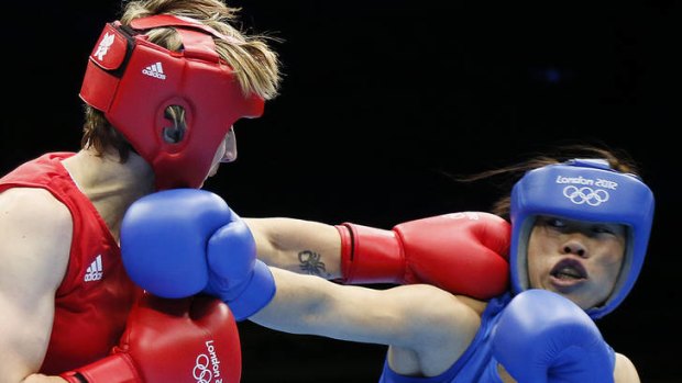 Karolina Michalczuk, left, of Poland defends against Chungneijang Mary Kom Hmangte of India during the women's flyweight boxing round.