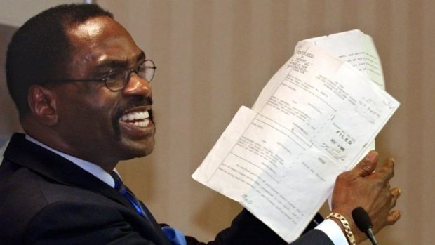 Rubin "Hurricane" Carter holds up the writ of habeas corpus that freed him from prison.