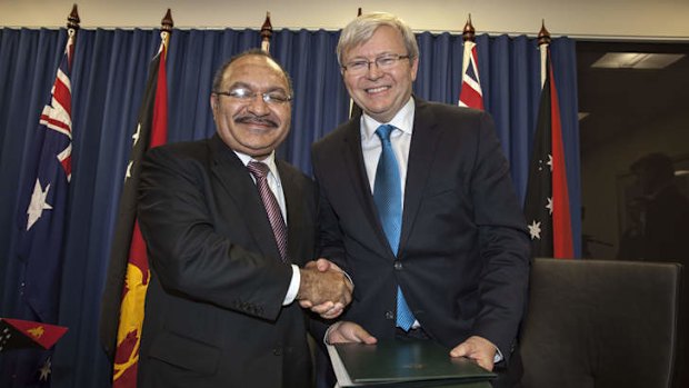 PNG's Prime Minister Peter O'Neill and Kevin Rudd shake hands over an asylum seeker deal on July 19.