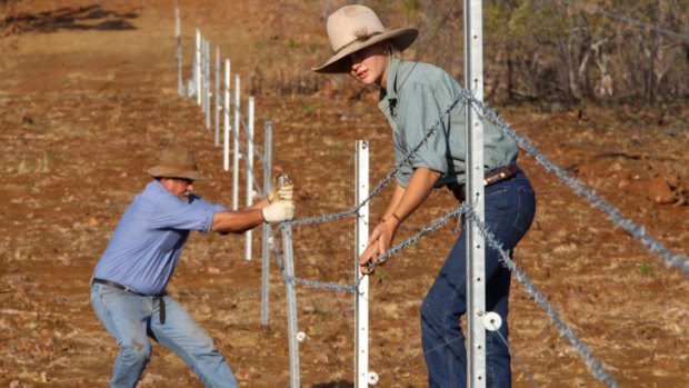 Wongalara Sanctuary manager  Chris Whatley and his daughter Melissa with the electric  fence.