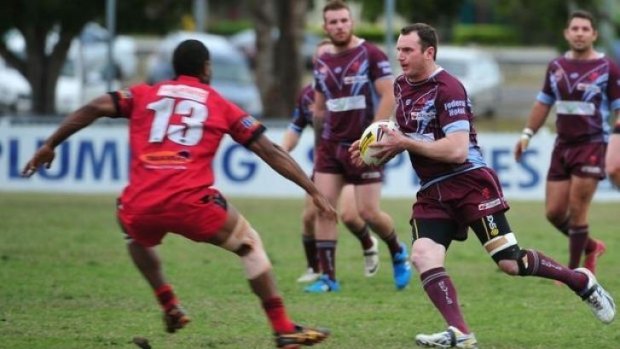 Isis Devils' Matthew Curtis gains ground in the A Grade Grand Final.