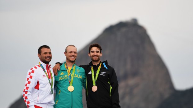 RIO DE JANEIRO, BRAZIL - AUGUST 16:  (L-R) Silver medalist Tonci Stipanovic of Croatia, gold medalist Tom Burton of Australia and bronze medalist Sam Meech of New Zealand celebrate on the podium for the Men's Laser class on Day 11 of the Rio 2016 Olympic Games at the Marina da Gloria on August 16, 2016 in Rio de Janeiro, Brazil.  (Photo by Laurence Griffiths/Getty Images)