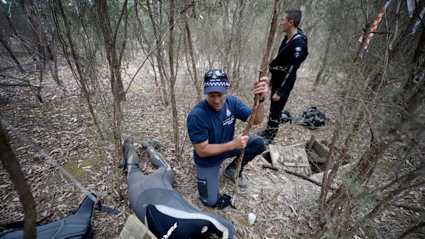 Police search an underwater tank near where Luke Shambrook went missing.