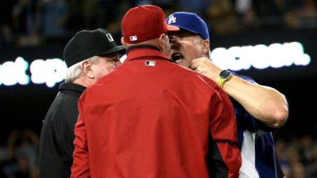 No love lost: Dodgers batting coach Mark McGwire has words with Arizona manager Kirk Gibson.