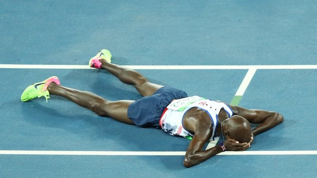Mo Farah collapses on the track after his win.