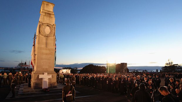 Veterans, dignitaries and members of the public stand around the Cenotaph at the Auckland War Memorial Museum during the ANZAC Day Dawn Service.
