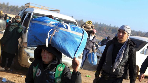 A young boy is one of thousands evacuated from Aleppo on Monday.