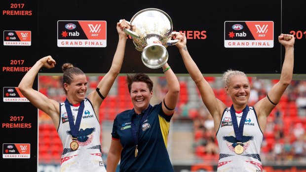 Chelsea Randall, Bec Goddard and Erin Phillip hold the cup aloft after the Crows won the inaugural AFLW Premiership against the Lions