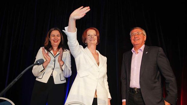 Prime Minister Julia Gillard, Queensland Labor leader Annastacia Palaszczuk (left) and Treasurer Wayne Swan (right) acknowledge the crowd at the Queensland Labor State Conference in Brisbane.