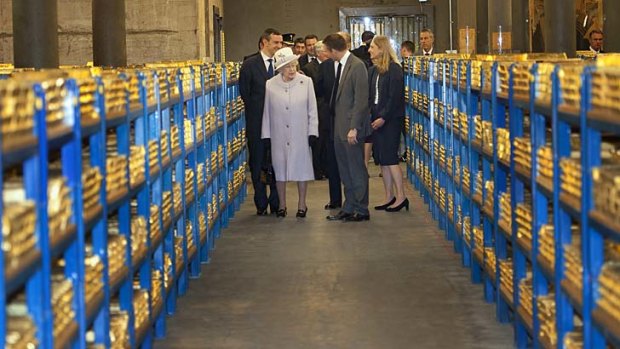 Worth a mint ... the Queen inspects a gold vault during a visit to the Bank of England.