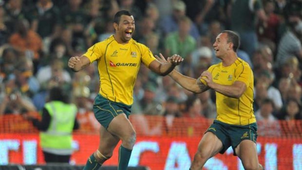 Kurtley Beale celebrates his winning penalty goal against South Africa with Quade Cooper.