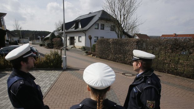 Police hold media away from the house where Andreas Lubitz lived in Montabaur, Germany.