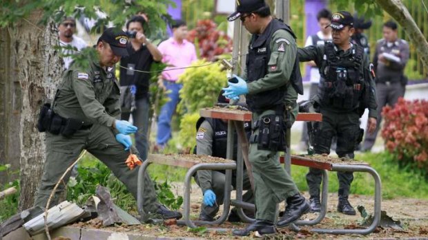 Thai security inspect the site of a bomb attack at a school in Yala province, south of Bangkok, which killed two soldiers and injured a student.