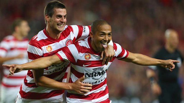 Shinji Ono celebrates a goal with teammate Tomi Juric.