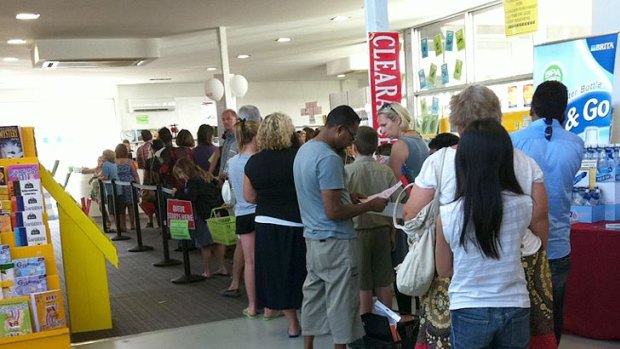 Parents and children queue for books at the Wooldridges book store in Osborne Park yesterday afternoon.