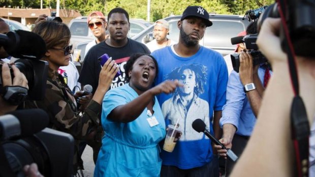 A woman voices her displeasure after the name of the officer involved in the shooting of Michael Brown was released in Ferguson, Missouri.
