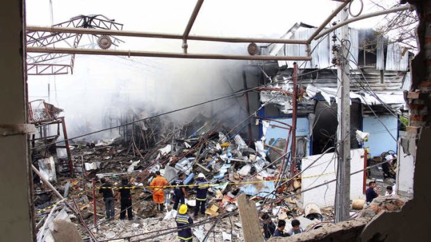 Picking up the pieces: Thai firefighters fight the blaze.