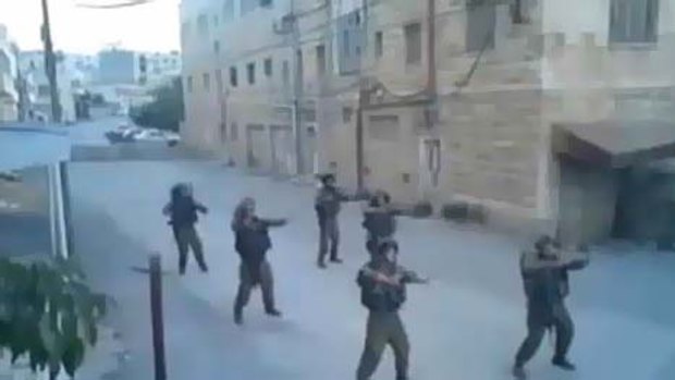 Six Israeli soldiers perform a dance routine in the deserted streets.