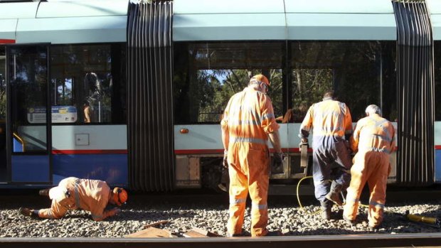 Rail Corp repair a train at the Rozelle Bay which derailed from the tracks on Monday night.