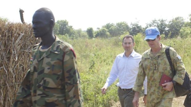 Australian Colonel Mike Chadwick (blue hat) escorts Toby Lanzer, UN assistant secretary-general in Juba, South Sudan on recent field trip to Pochalla, Jonglei province.