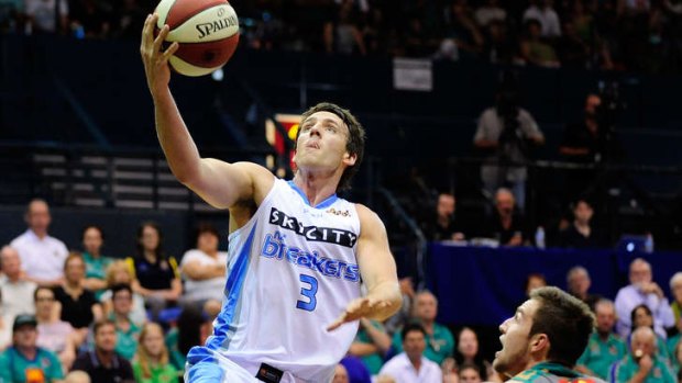 Breakers guard Daryl Corletto makes a lay up past Mitch Norton of the Crocodiles at Townsville Entertainment Centre.