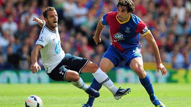 Roberto Soldado of Tottenham Hotspur is tackled by Mile Jedinak of Crystal Palace during the EPL game on Sunday.