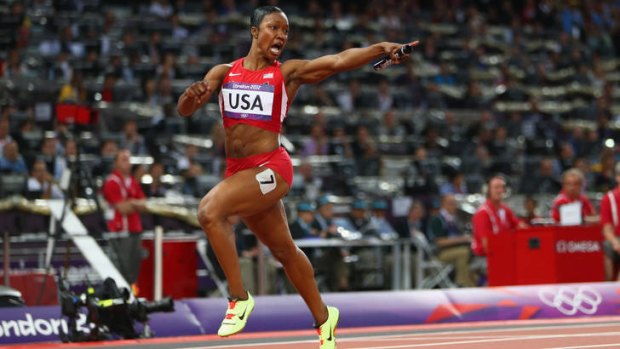 That's a record ... Carmelita Jeter points to the clock after she crosses the line.
