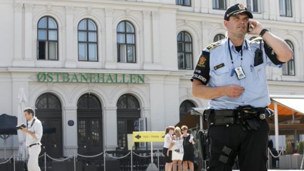 High alert: Armed police stand guard at the Central Railway Station in Oslo.