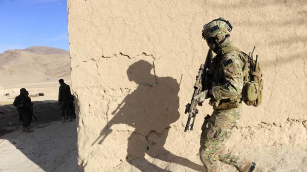 On alert &#8230; an Australian soldier's shadow looms large while on patrol with his Afghan National Army counterparts.
