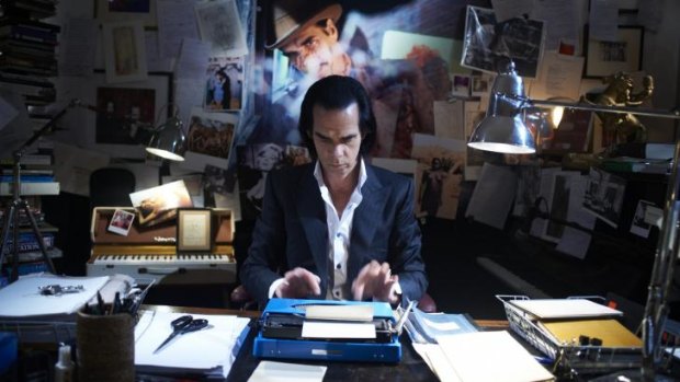 Cave cave: Nick Cave at work in his dimly lit and cluttered study in which he writes his songs.