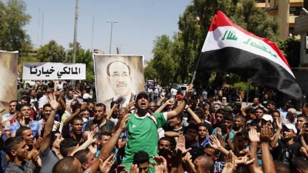 Iraqis gather to support Iraqi Prime Minister Nouri al-Maliki in Baghdad.
