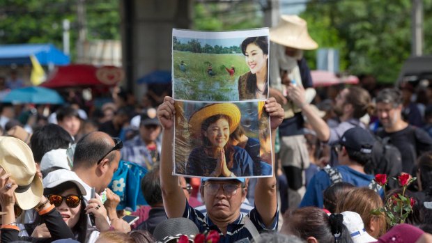 Supporters of Thailand's former Prime Minister Yingluck Shinawatra defy orders not to gather and mass outside the Supreme Court in Bangkok on Friday.