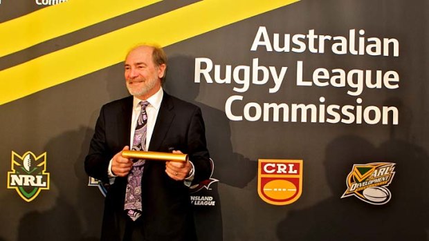 John Grant, chairman of the inaugural Australian Rugby League Commission, with the rugby league leadership baton handed to him.