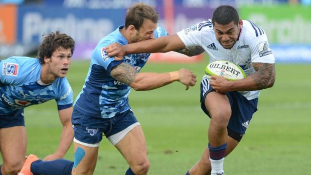 Nabbed: Charles Piutau of the Blues is tackled by Francois Hougaard of the Bulls.